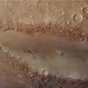 Illustration for article titled This bizarre elongated crater is a Martian mystery
